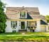 White single-family house exterior with front lawn and garden
